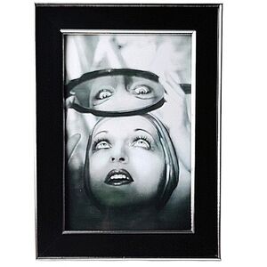 Vintage Beauty Woman getting her eyebrows waxed looking in mirror framing photo